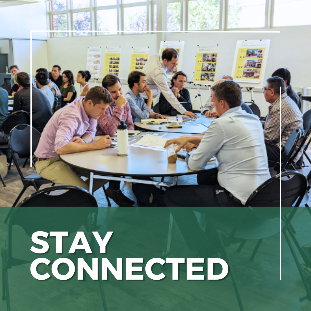 Stay Connected roundtable of various people reviewing handouts in a meeting room