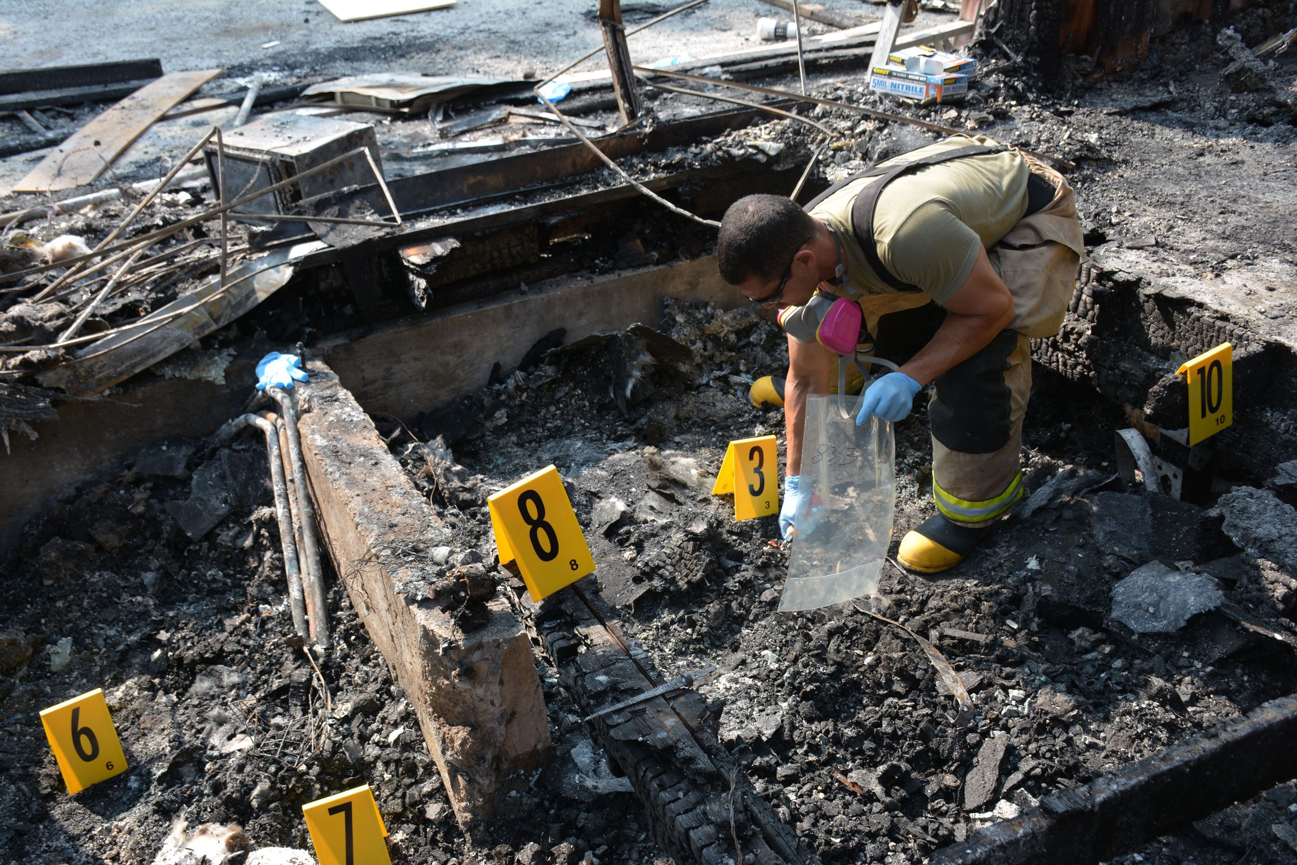 Arson investigator examining a crime scene.