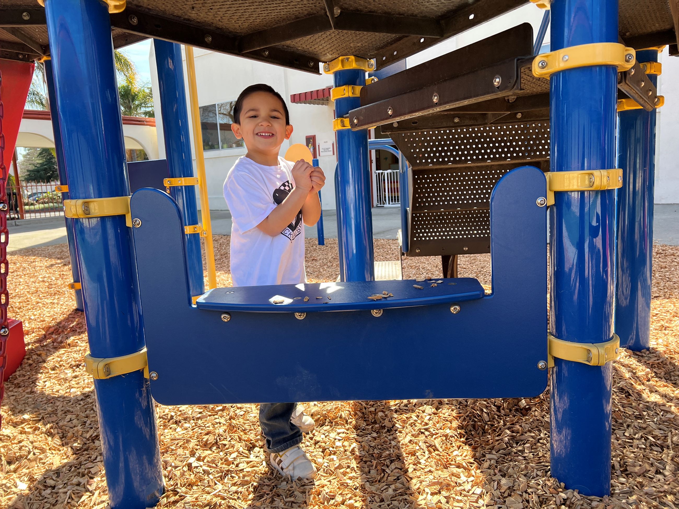preschool student on playground smiling