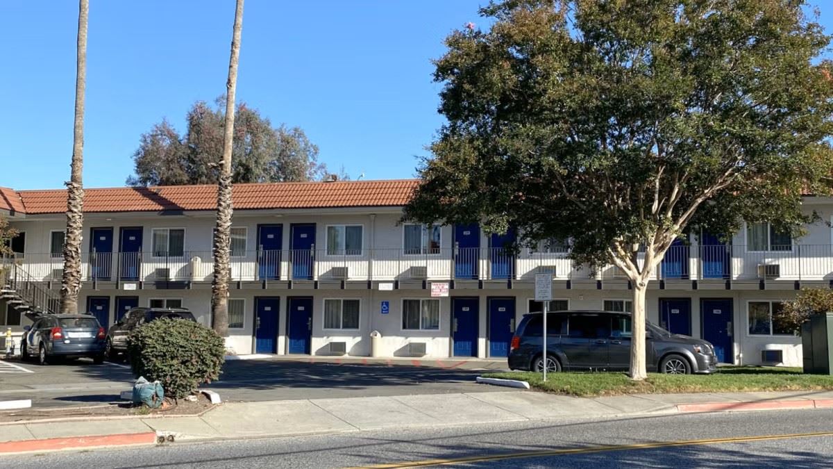 photo of two-story motel with blue doors